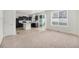 Spacious kitchen area with black cabinetry, a center island, and modern appliances at 5550 Malta St, Denver, CO 80249