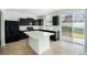 Stylish kitchen features dark cabinets, white countertops, and a convenient center island at 5550 Malta St, Denver, CO 80249