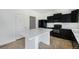 Bright kitchen with black appliances, white countertops, and center island for food preparation at 5550 Malta St, Denver, CO 80249
