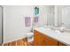 Well-lit bathroom with wood floors, and a glass door shower at 8520 S Holland Ln # 102, Littleton, CO 80128