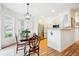 Bright dining area near the kitchen, featuring hardwood floors, natural light, and a pendant light fixture at 8520 S Holland Ln # 102, Littleton, CO 80128