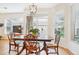 Bright dining area next to a sliding glass door, featuring hardwood floors and a view of the backyard at 8520 S Holland Ln # 102, Littleton, CO 80128