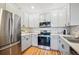 Kitchen with stainless steel appliances, light gray cabinets, and hardwood floors at 8520 S Holland Ln # 102, Littleton, CO 80128