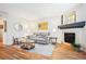 A welcoming living room featuring a cozy fireplace, hardwood floors, and comfortable seating at 8520 S Holland Ln # 102, Littleton, CO 80128