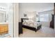 Cozy main bedroom with soft carpet, neutral decor, and an ensuite bathroom at 8520 S Holland Ln # 102, Littleton, CO 80128
