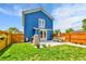 Spacious backyard with green grass, patio, dining table, and wood fence perfect for outdoor gatherings at 3178 N Race St, Denver, CO 80205