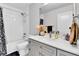 Bright bathroom featuring a shower over tub, subway tile surround, and gray vanity with white countertop at 3178 N Race St, Denver, CO 80205