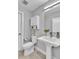 Stylish bathroom with pedestal sink, modern fixtures, and white cabinetry, offering a clean and bright aesthetic at 3178 N Race St, Denver, CO 80205