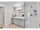 Modern bathroom with updated vanity, framed mirror, glass enclosed shower with tile surround at 3178 N Race St, Denver, CO 80205