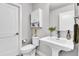 Stylish bathroom with pedestal sink, modern fixtures, and white cabinetry, offering a clean and bright aesthetic at 3178 N Race St, Denver, CO 80205