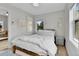 Neutral bedroom with natural light, comfortable bedding, light colored walls, and wood-look flooring at 3178 N Race St, Denver, CO 80205