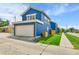 Beautiful blue home with a two-car garage and a well-maintained lawn on a sunny day at 3178 N Race St, Denver, CO 80205