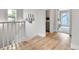 Hallway with wood floors, natural light, staircase, and decorative photos on the wall at 3178 N Race St, Denver, CO 80205