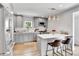 Updated kitchen featuring grey cabinets, stainless steel appliances, pendant lighting, and breakfast bar at 3178 N Race St, Denver, CO 80205