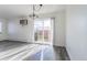 Living room view of the balcony and exterior with large sliding glass doors and grey laminate flooring at 5995 W Hampden Ave # 17C, Denver, CO 80227