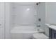 Bright bathroom featuring a white shower and tub combination with built-in shelving and an updated showerhead at 5995 W Hampden Ave # 17C, Denver, CO 80227