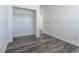 A bedroom with wood-look floors, a walk-in closet, and fresh white walls at 5995 W Hampden Ave # 17C, Denver, CO 80227