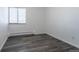 A bright room features wood-look floors, a window and neutral walls at 5995 W Hampden Ave # 17C, Denver, CO 80227