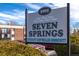 Sign for the Seven Springs Covenant Controlled Community, with landscaped bushes at 5995 W Hampden Ave # 17C, Denver, CO 80227