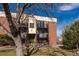 Exterior view of a brick apartment building featuring multiple balconies and staircases at 5995 W Hampden Ave # 17C, Denver, CO 80227