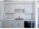 Bright kitchen has stainless steel sink, white cabinets and a black dishwasher at 5995 W Hampden Ave # 17C, Denver, CO 80227