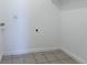 Laundry room area with a neutral tiled floor and white walls, ready for washer and dryer hookups at 5995 W Hampden Ave # 17C, Denver, CO 80227
