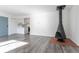 Open concept living area with a unique fireplace, laminate flooring, and seamless flow into the kitchen at 5995 W Hampden Ave # 17C, Denver, CO 80227