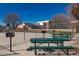 Outdoor picnic area featuring multiple green tables and barbeque grills, perfect for gatherings at 5995 W Hampden Ave # 17C, Denver, CO 80227
