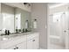 Modern bathroom with double vanity and shower/tub combo at 10270 E 62Nd Pl, Denver, CO 80238