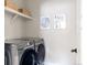 Convenient laundry room with washer, dryer and shelving at 10270 E 62Nd Pl, Denver, CO 80238