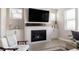 Cozy living room featuring a fireplace and built-in shelving at 10270 E 62Nd Pl, Denver, CO 80238