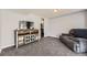 Finished basement featuring plush carpeting, a comfortable couch, and a modern entertainment center at 10685 W Apishapa Pass, Littleton, CO 80127
