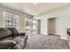 Spacious finished basement featuring sliding glass doors, plush carpeting, and ample natural light at 10685 W Apishapa Pass, Littleton, CO 80127