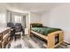 Comfortable bedroom featuring a wood bed frame, wood-look floors, and a desk at 10685 W Apishapa Pass, Littleton, CO 80127