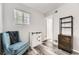Stylish bedroom features wood-look floors, ample natural light, and a comfortable armchair at 10685 W Apishapa Pass, Littleton, CO 80127