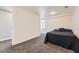 Cozy bedroom featuring neutral carpet, light walls, and a bright window for lots of natural lighting at 10685 W Apishapa Pass, Littleton, CO 80127