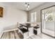Bright dining area features custom booth seating, modern lighting, and sliding glass door for outdoor access at 10685 W Apishapa Pass, Littleton, CO 80127