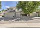 Two-story townhome featuring a two-car garage, easy-to-maintain landscaping, and classic exterior design at 10685 W Apishapa Pass, Littleton, CO 80127