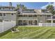 Exterior shot of the backyard with a deck, patio, and a lush, well-manicured lawn at 10685 W Apishapa Pass, Littleton, CO 80127