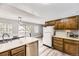 Well-lit kitchen offers stainless steel appliances, bright countertops, and easy access to the outdoor patio at 10685 W Apishapa Pass, Littleton, CO 80127