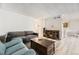 Open-concept living area features wood-look floors, neutral walls, and ample space for entertaining at 10685 W Apishapa Pass, Littleton, CO 80127