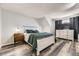 Serene main bedroom boasts wood-look floors, a whitewashed bed frame, and a large window at 10685 W Apishapa Pass, Littleton, CO 80127