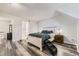 Comfortable main bedroom featuring rustic furniture, wood-look floors, and a dog ramp at 10685 W Apishapa Pass, Littleton, CO 80127