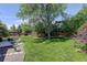 Sprawling backyard with a deck, lounge chairs, a pergola, and a lush lawn at 7877 W 110Th Dr, Westminster, CO 80021