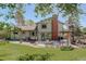 Spacious backyard featuring a deck with outdoor seating and a well-maintained lawn at 7877 W 110Th Dr, Westminster, CO 80021