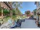 Backyard deck features lounge chairs, dining table, and beautiful landscaping at 7877 W 110Th Dr, Westminster, CO 80021