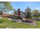 Expansive backyard with a deck, patio furniture, lush lawn, and fenced garden area at 7877 W 110Th Dr, Westminster, CO 80021