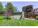 Backyard shed surrounded by mature trees and landscaping at 7877 W 110Th Dr, Westminster, CO 80021