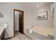 Bathroom showing a large soaking tub, carpeted steps, and wood trim at 7877 W 110Th Dr, Westminster, CO 80021