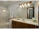 Bathroom showcasing a sink with wood cabinets and a sliding glass shower at 7877 W 110Th Dr, Westminster, CO 80021
